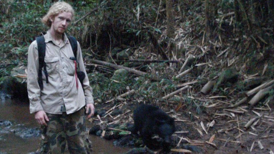 Brian Crudge, from Cobh in Co Cork, walks a bear at the rescue centre where he works in Cambodia. Bears in the region are vulnerable to poaching for their bile, which is prized in Chinese medicine.