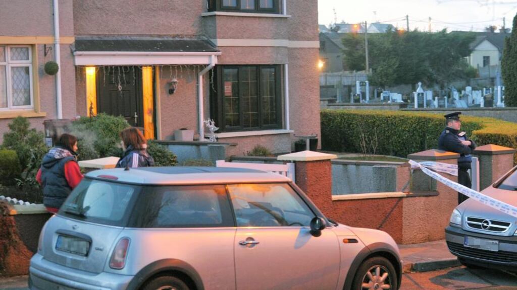 Neighbours and gardaí at the scene of the double fatal stabbing in O’Neill Place, Cobh, Co Cork. Photograph: Daragh Mc Sweeney/Provision