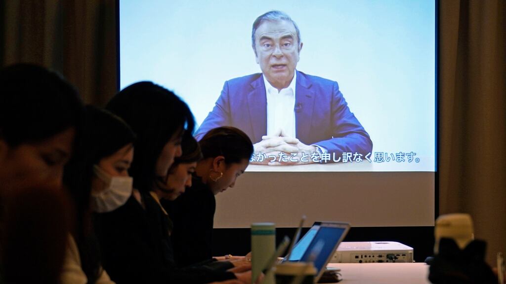 Reporters work while a screen shows a video recorded by Carlos Ghosn, during a press conference at the Foreign Correspondents’ Club of Japan in Tokyo. Photograph: Franck Robichon/EPA