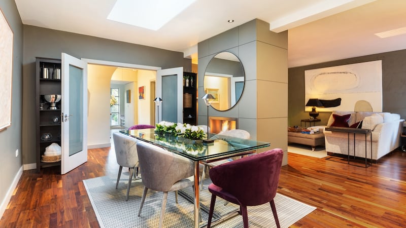Dining room with dual-aspect gas fire in divider panel opening into family room.