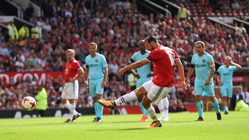 Ruud van Nistelrooy scores a penalty for Manchester United Legends against Barcelona. Photograph: Nathan Stirk/Getty