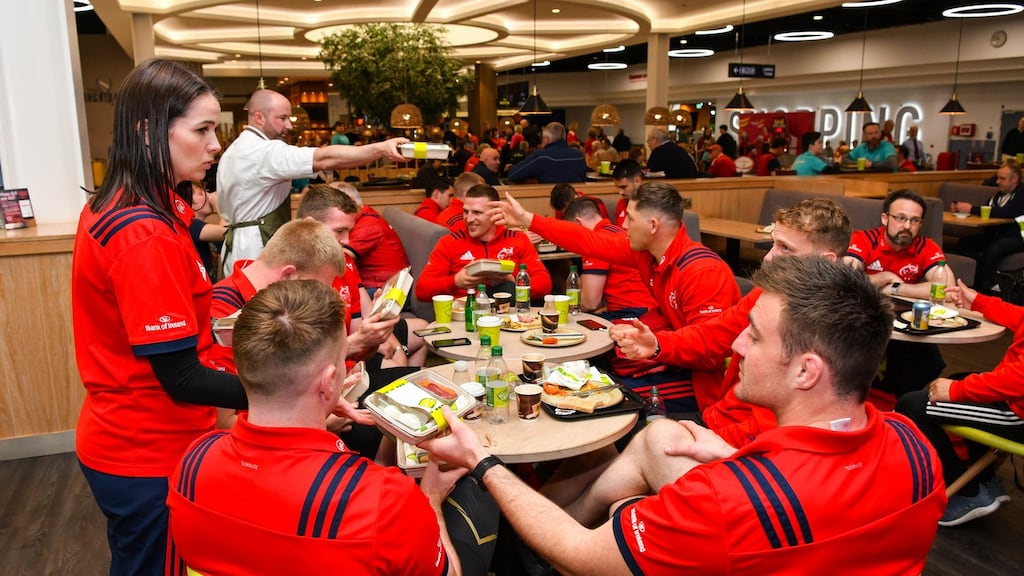 Emma Tester, lead performance nutritionist at Munster Rugby, and Zest! executive chef Danny Miller hand out snack packs to Munster players at Zest! cafe, in Shannon. Photograph: Diarmuid Greene