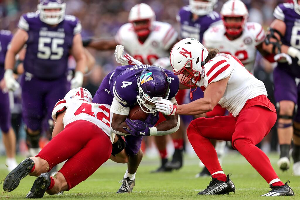 Northwestern’s Cam Porter is tackled by Nick Henrich and Eteva Mauga-Clements of Nebraska in Dublin. Photograph: Laszlo Geczo/Inpho