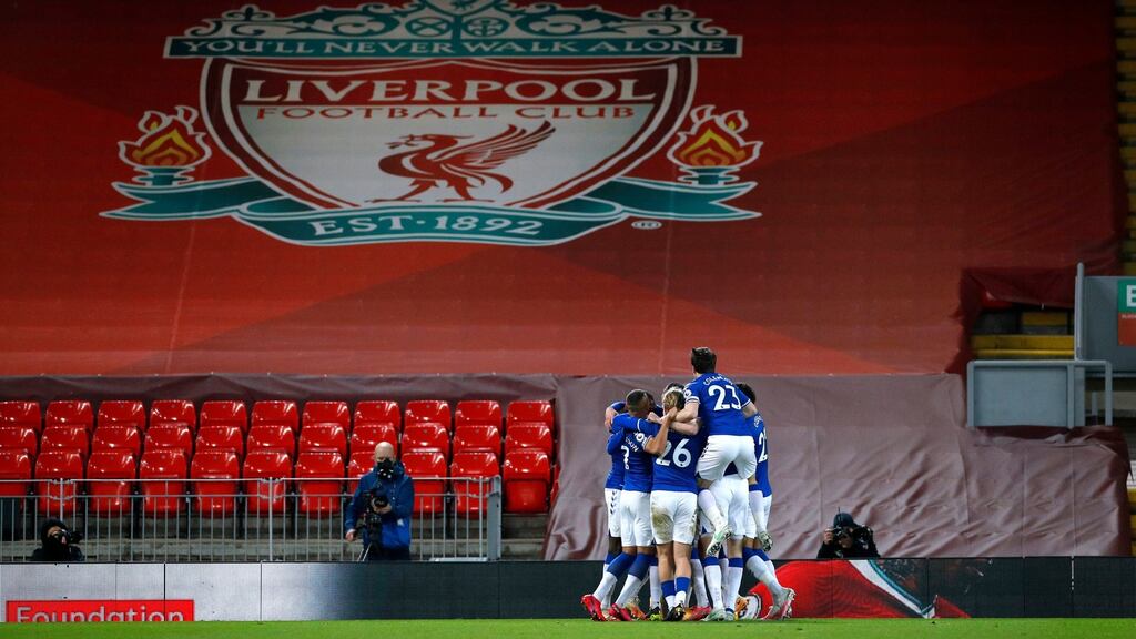 Everton players celebrate their second goal at an empty Anfield. Photograph: PA