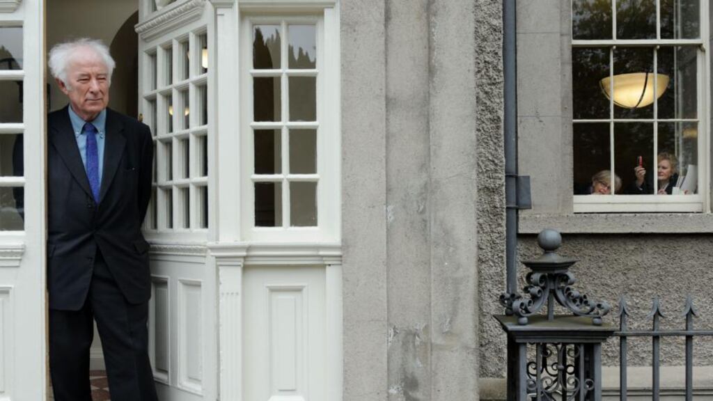 Two women look out at Seamus Heaney during a photocall in IMMA celebrating his 70th birthday today in April 2009. Photograph: Aidan Crawley