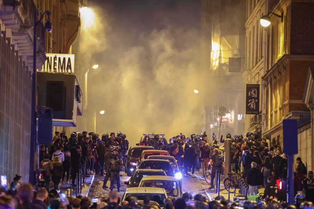 Riot police forces clash with demonstrators near the Arc de triomphe during another night of clashes with protestors in Paris, France, on Saturday. Violence broke out all over France after police fatally shot a 17-year-old teenager during a traffic stop in Nanterre. Photograph: Mohammed Badra/EPA