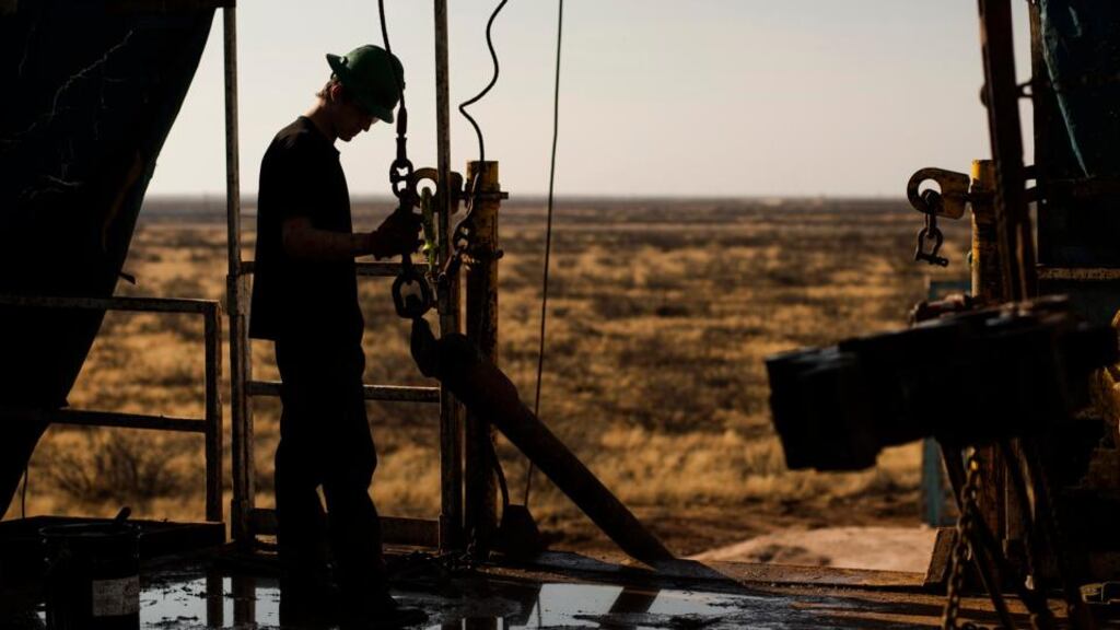 A worker waits to connect a drill bit on Endeavor Energy Resources LP’s Big Dog Drilling Rig 22 in the Permian basin outside of Midland, Texas. Of all the booming US oil regions set soaring by a drilling renaissance in shale rock, the Permian and Bakken basins are among the most vulnerable to lower oil prices. Photograph: Brittany Sowacke/Bloomberg