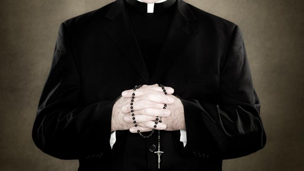 A priest holding prayer beads