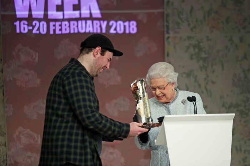 Queen Elizabeth II presents Richard Quinn with the inaugural Queen Elizabeth II Award for British Design at London Fashion Week. Photograph: Getty