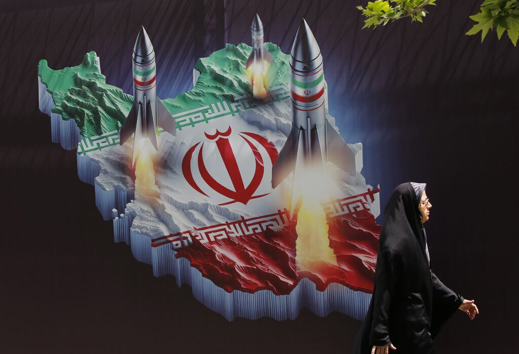 A woman walks past an anti-Israel banner carrying pictures of Iranian missiles, in Tehran on Tuesday. Photograph: Abedin Taherkenareh/EPA