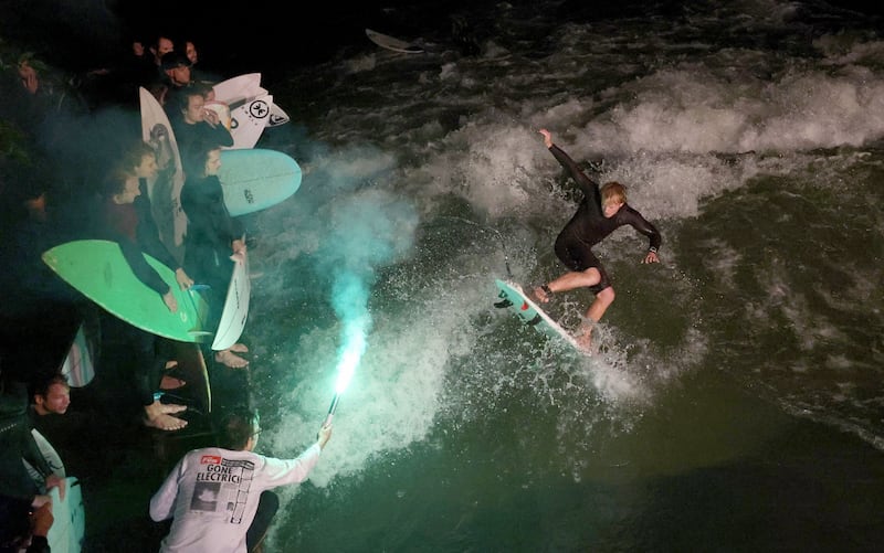 A surfer rides a wave at Eisbach creek in Munich, Germany in 2023. Photograph: EPA