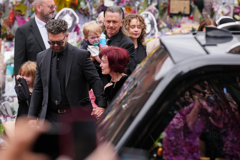 Jack Osbourne, Sharon Osbourne, Kelly Osbourne (hidden) and family members stop to view tributes to the late Ozzy Osbourne from fans. Photograph: Christopher Furlong/Getty Images