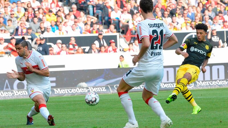 Borussia Dortmund’s English midfielder Jadon Sancho scores the opening goal in the Bundesliga game away to VfB Stuttgart. Photograph: Thomas Kienzle/AFP/Getty Images