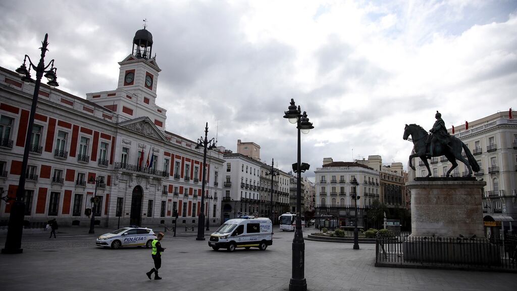Members of the Military Emergency Unit of the Spanish army and municipal police officers patrol the iconic Puerta del Sol square in Madrid. Photograph: Reuters