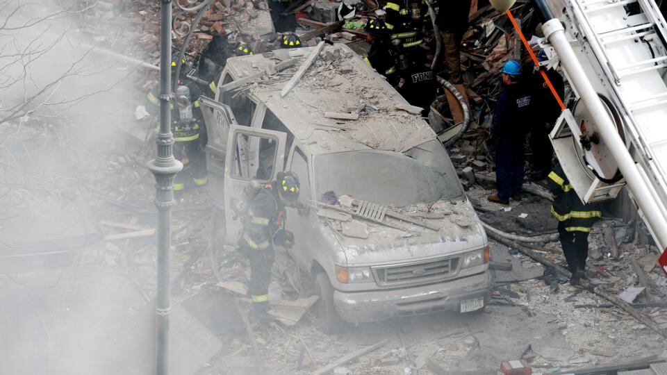 Firefighters at the scene of at least one building damaged by fire and a possible explosion in New York today. The cause of the explosion and fire has not been determined. Photograph: EPA