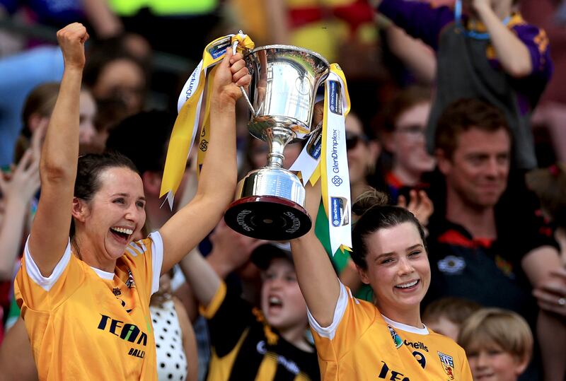 Antrim’s Maria McLarnon and Emma Laverty lift the Kay Mills Cup. Photograph: Leah Scholes/Inpho