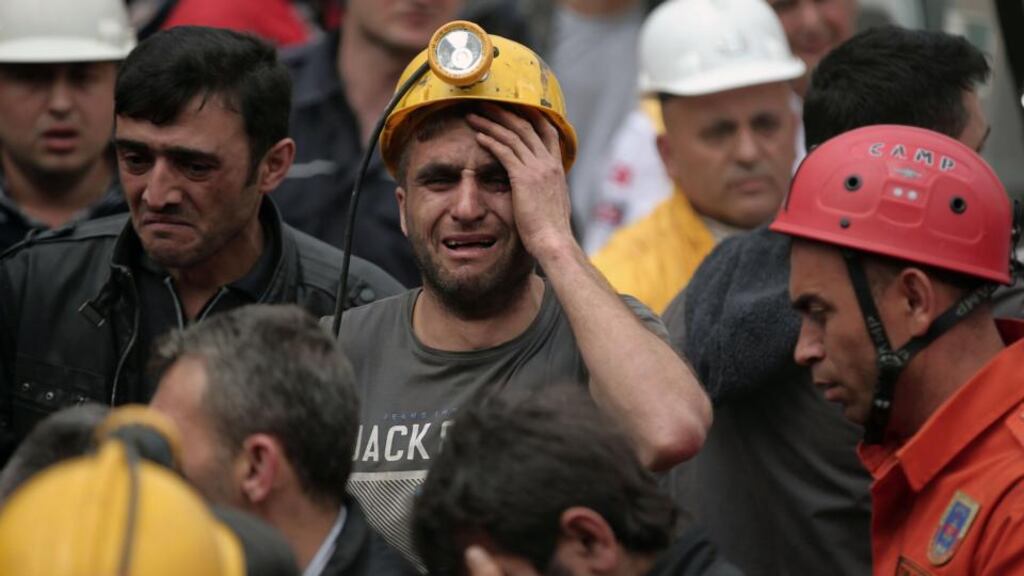 A miner cries as rescue workers carry the dead body of a miner from the mine in Soma, western Turkey, yesterday. Photograph: Emrah Gurel/AP