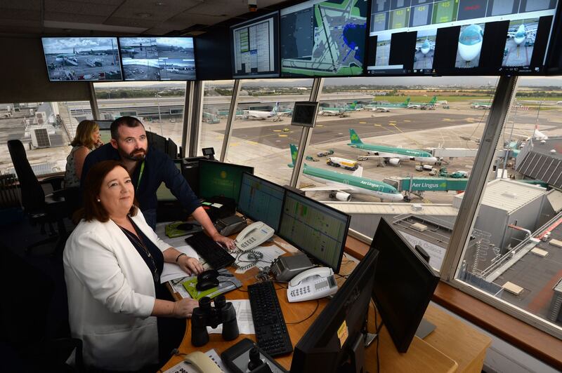 Dublin Airport: Adrienne Peers and Eoin Burke in the Pod, where they allocate aircraft stands. Photograph: Dara Mac Dónaill