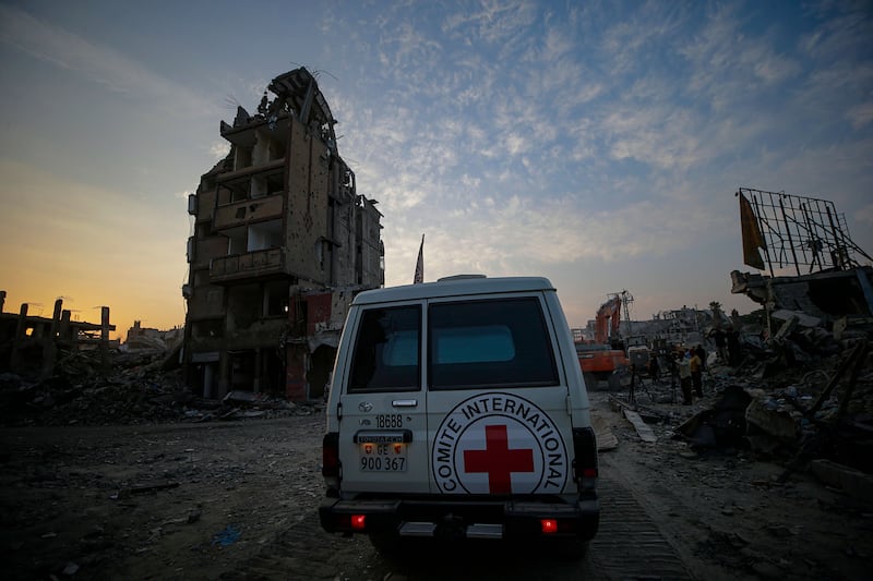 Hamas armed wing says it will hand over body of hostage as airstrikes continue in Gaza