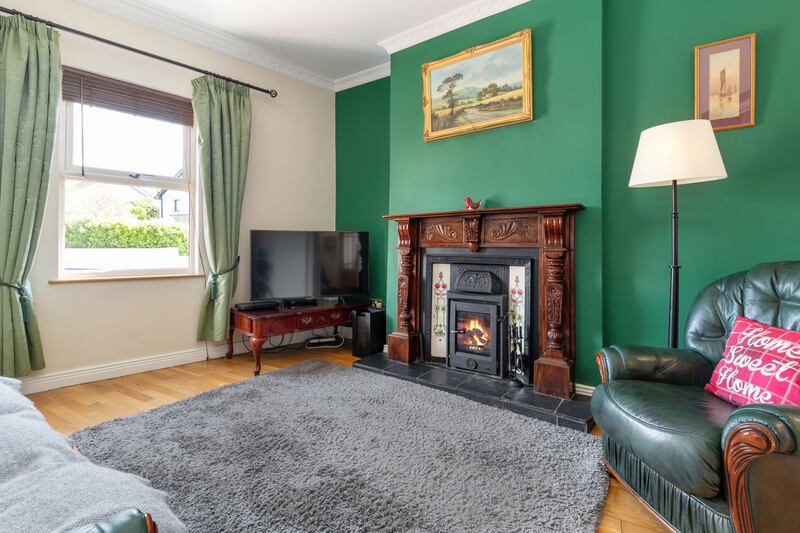 The sittingroom is to the left of the hallway; painted forest green, it benefits from decorative original cornicing and a ceiling rose. Photograph: Keith Owens