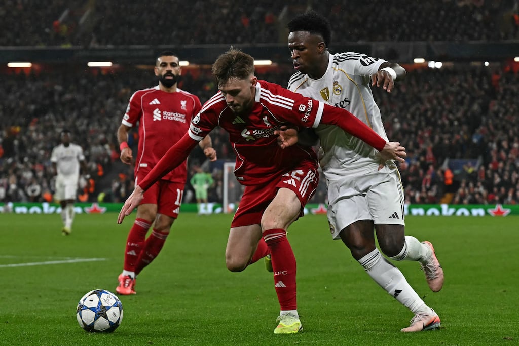 Liverpool defender Conor Bradley vies with Real Madrid forward Vinicius Junior during the UEFA Champions League league phase football match at Anfield. Photograph: Paul Ellis/Getty Images