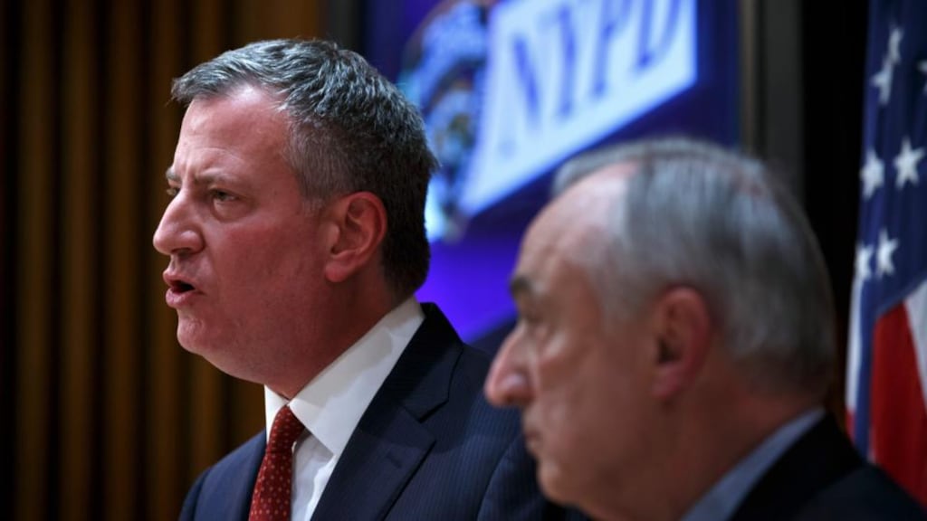 New York mayor Bill de Blasio (left) appealed for calm in the aftermath of the killing of two officers, who were gunned down as they sat in their patrol car. Photograph: Richard Perry/The New York Times