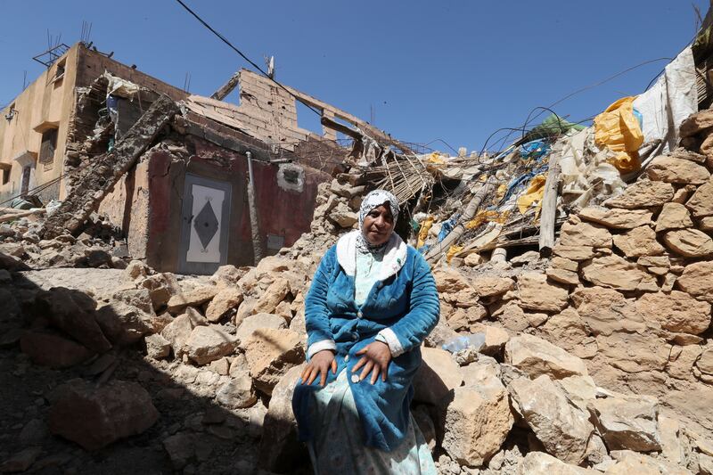 A woman sits next to the rubble of her damaged house in Moulay Brahim, after Friday's powerful earthquake. Photograph: Mohamed Messara/EPA
