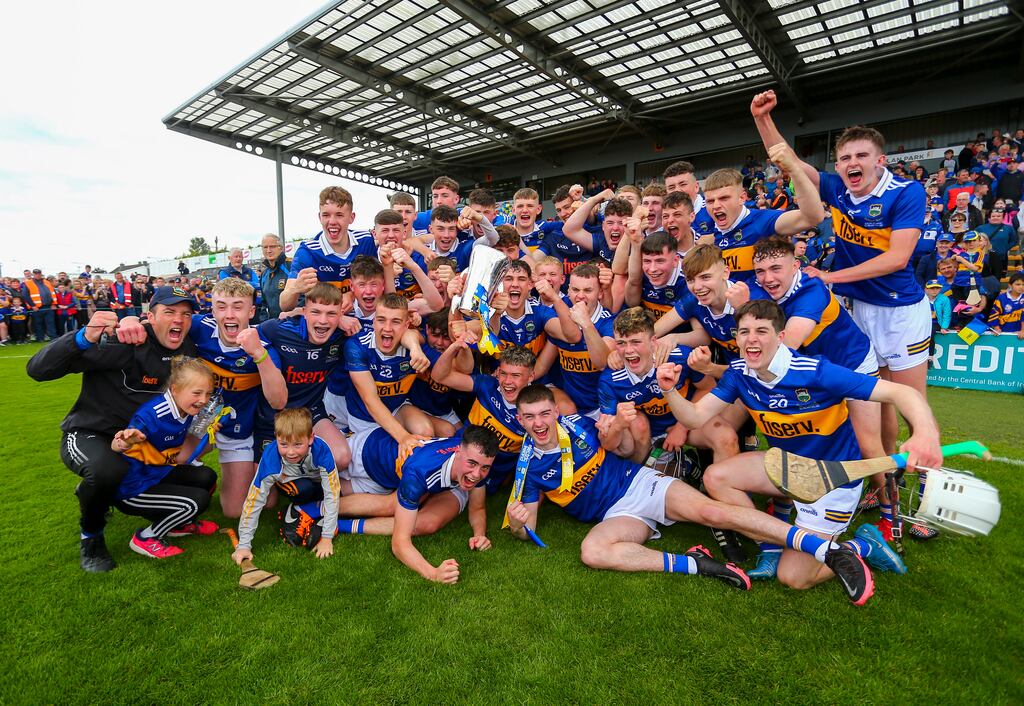Tipperary players and manager James Woodlock celebrate with the trophy after the victory over Offaly in the Electric Ireland All-Ireland Minor Hurling Championship Final at UPMC Nowlan Park. Photograph: Ken Sutton/Inpho