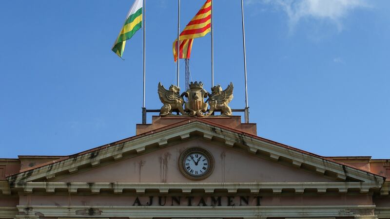The Catalan and Sabadell municipal flags fly next to bare flag poles where the Spanish and European Union flags previously flew. Photograph: Albert Gea/Reuters