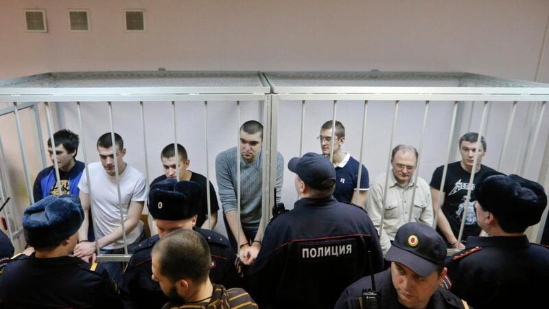 Defendants in the ‘Bolotnaya’ case stand in a holding cell as they wait for their sentencing during the court hearing in Moscow on Monday. Photograph: Maxim Shemetov/Reuters
