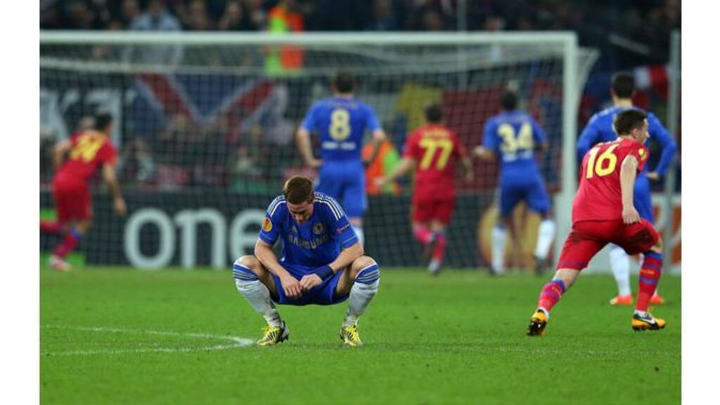 Fernando Torres looks away as Raul Rusescu of FC Steaua scores his penalty past Petr Cech. Photograph: Julian Finney/Getty Images