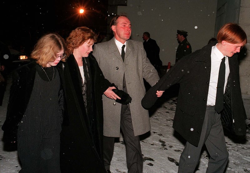Ray Quinn with his and Joyce’s children, Lisa, Nicole and David, at the removal of Joyce’s remains, at St Brigid’s Church in Kildare town in 1996. Photograph: Frank Miller