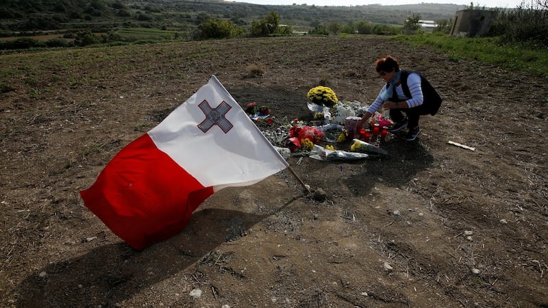 A woman places flowers at the scene of the assassination of Daphne Caruana Galizia, killed in a car bomb attack in Bidnija, Malta on October 26th, 2017. Photograph: Darrin Zammit Lupi/Reuters