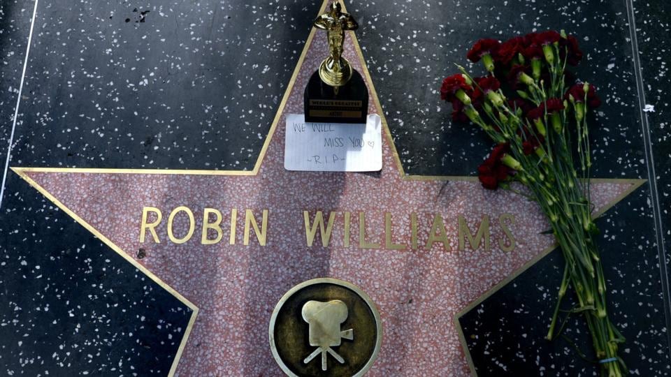 Flowers, an Oscar souvenir and a note reading ‘We Miss You RIP’ is placed on the Hollywood Walk of Fame star for US actor Robin Williams in Hollywood, California. Photograph: Michael Nelson/EPA
