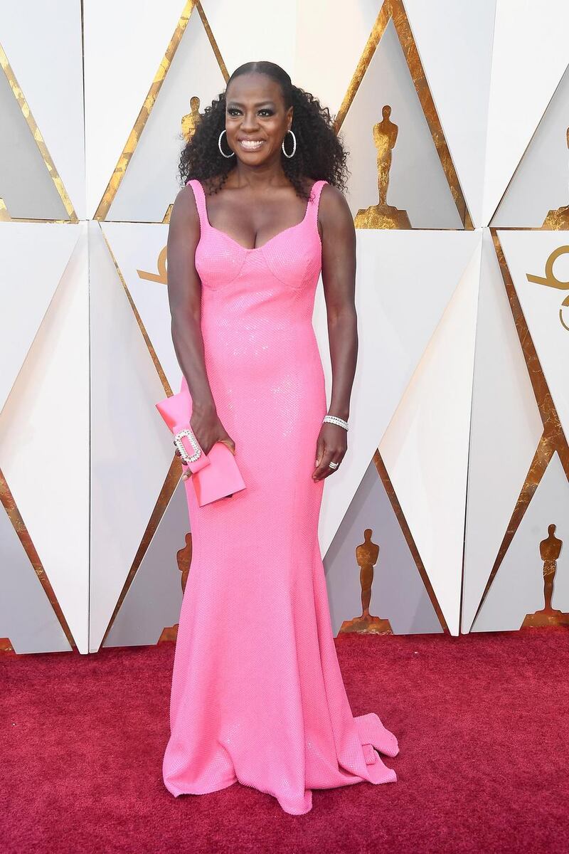 Viola Davis picked a hot pink shade gown coordinating with a matching clutch in the same colour family