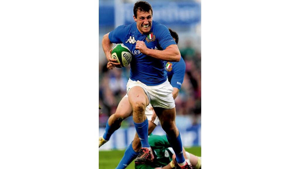 Tommaso Benvenuti of Italy slips the tackle of Ireland's Stephen Ferris during the RBS Six Nations match between Ireland and Italy at Aviva Stadium. photograph: jamie mcdonald