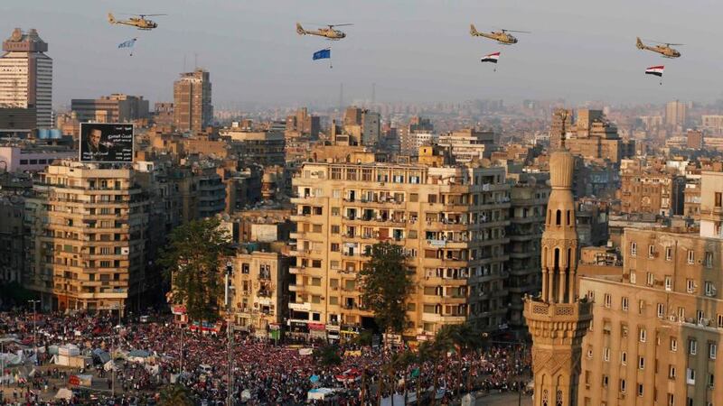 The Egyptian military carries out a fly-past  over crowds in Tahrir Square today after the overthrow of  President Mohamed Morsi. Photograph: Steve Crisp/Reuters