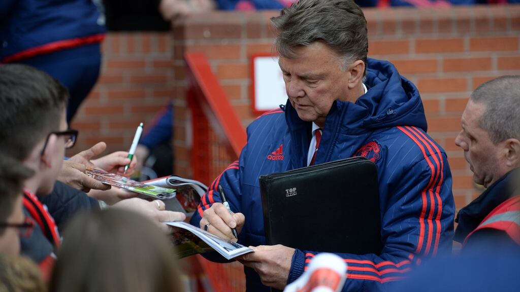 Manchester United’s Dutch manager Louis van Gaal signs autographs before last weekend’s game against Aston Villa. Photograph: Getty Images