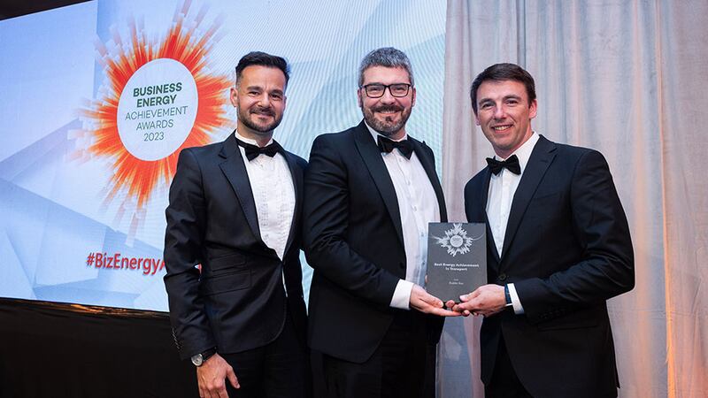 Conall Bolger, awards judge, presents the best energy achievement in transport award to Rafael Bernardes and Chris Holton, Dublin Bus
