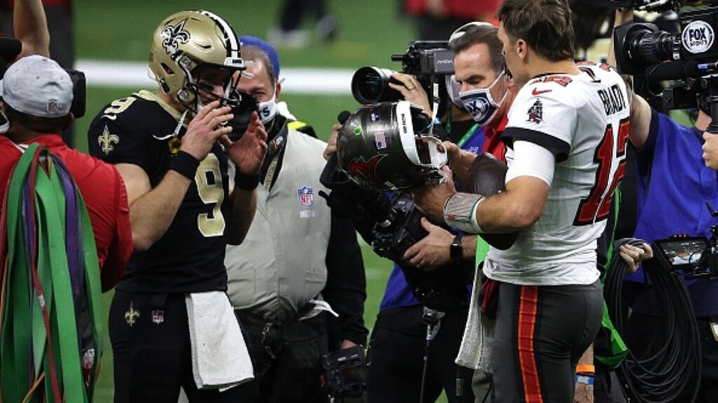 Drew Brees of the New Orleans Saints talks with Tom Brady of the Tampa Bay Buccaneers after their NFC Divisional Playoff game. Photograph: Getty Images
