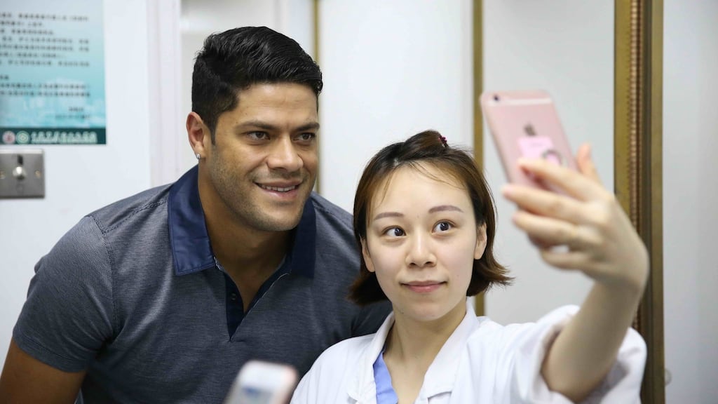 Brazil’s Hulk poses for photos with a nurse during a medical examination at a hospital in Shanghai. Photograph: Getty Images
