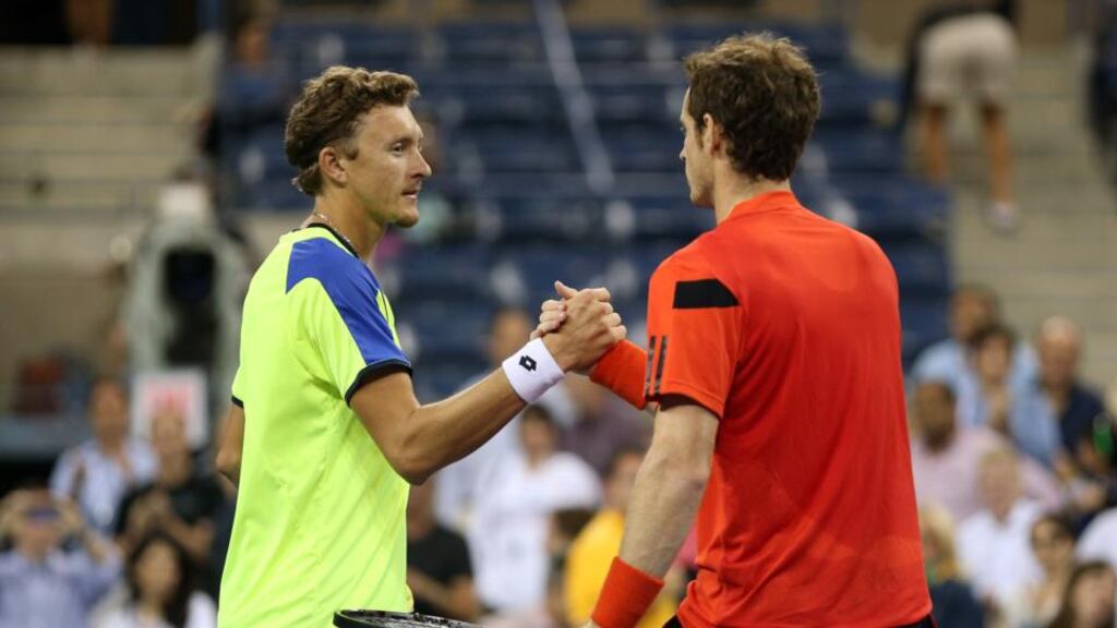Andy Murray Britain shakes hands at the net with Denis Istomin after their fourth round match. Photograph: Clive Brunskill/Getty Images