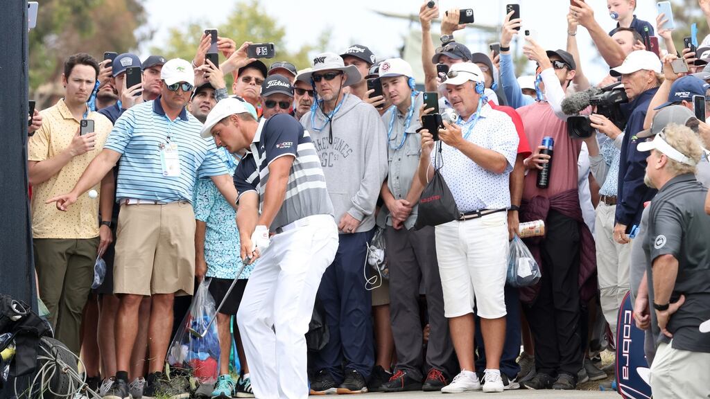Bryson DeChambeau plays a chip shot from the gallery area on the 13th hole during the final round of the US Open. Photo: Harry How/Getty Images