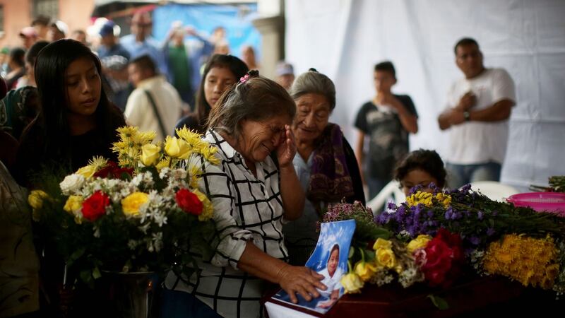 Family and friends mourn at the wake for seven victims of the eruption of the Guatemala volcano, in the central plaza of the municipality of Alotenango, Sacatepequez, Guatemala. Photograph: EPA/ESTEBAN BIBA