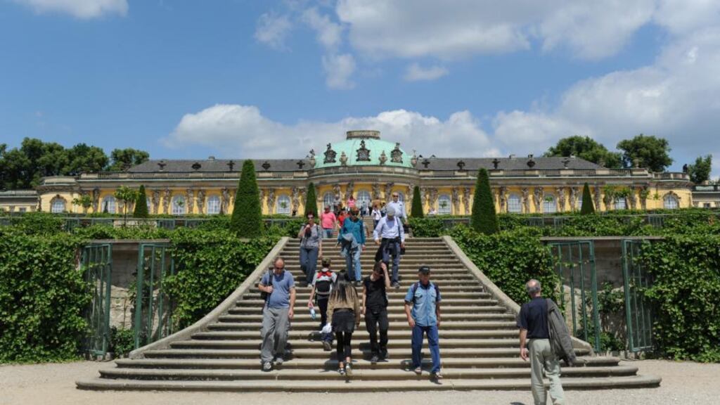 Tourists walk in the garden of Sanssouci Palace in Potsdam. Photograph: Johannes Eisele/AFP/Getty Images