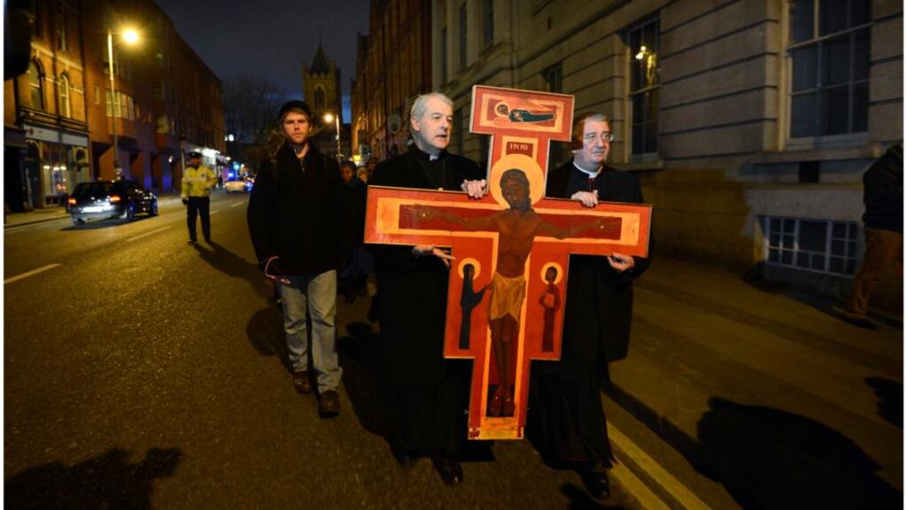 Archbishop Michael Jackson and Archbishop Diarmuid Martin carrying the Taize Cross down Dame Street, Dublin during the Good Friday procession last year. Photograph: Brenda Fitzsimons