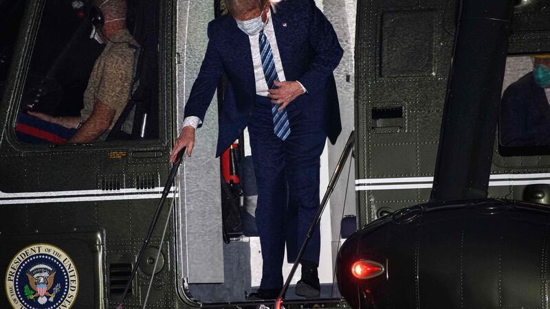 US president Donald Trump steps off Marine One wearing a face mask as he arrives at the White House upon his return from Walter Reed Medical Center, where he underwent treatment for Covid-19, in Washington. Photograph: Nicholas Kamm/AFP/Getty Images