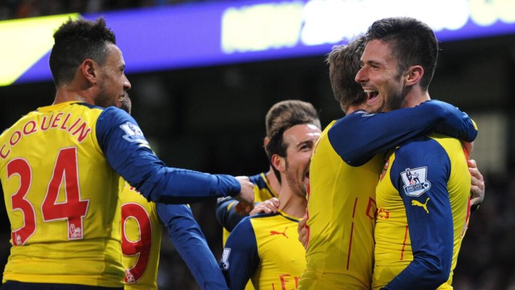 Arsenal’s Olivier Giroudis congratulated by his team-mates after scoring the second goal in his side’s 2-0 dwin over Manchester City at the Etihad Stadium. Phototograph: Peter Powell/EPA