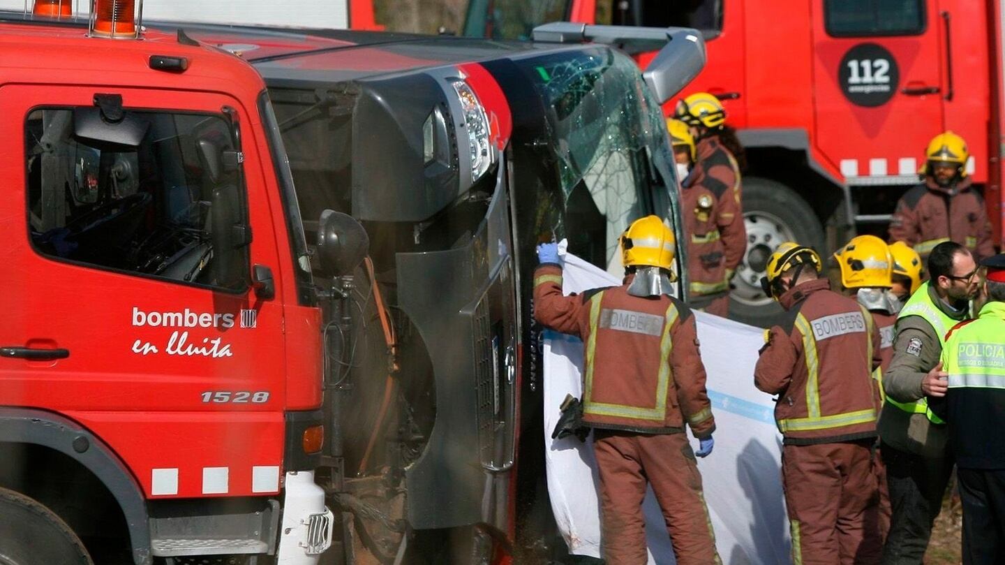 Firemen work at the site of a coach crash that has left at least 14 students dead in Spain. Photograph: EPA