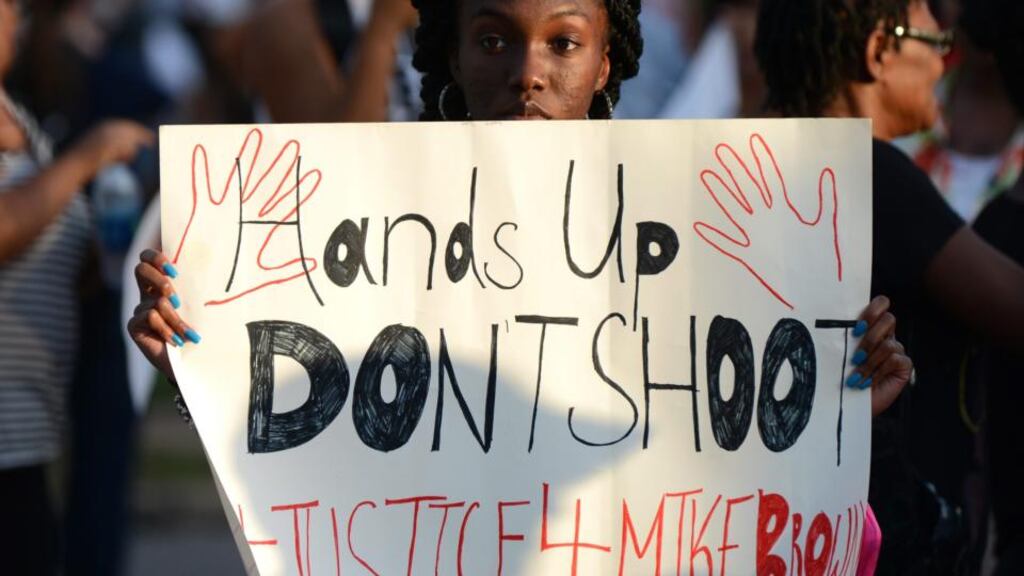 Protesters gather  in Ferguson, Missouri,  last year over the police killing of  Michael Brown. Two police killings function as the book’s emotional anchors, that of Brown and that of Coates’s college friend. Photograph: EPA